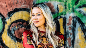 Anna Eriksson poseeraa värikkään taustan edessä promokuvassa 2025