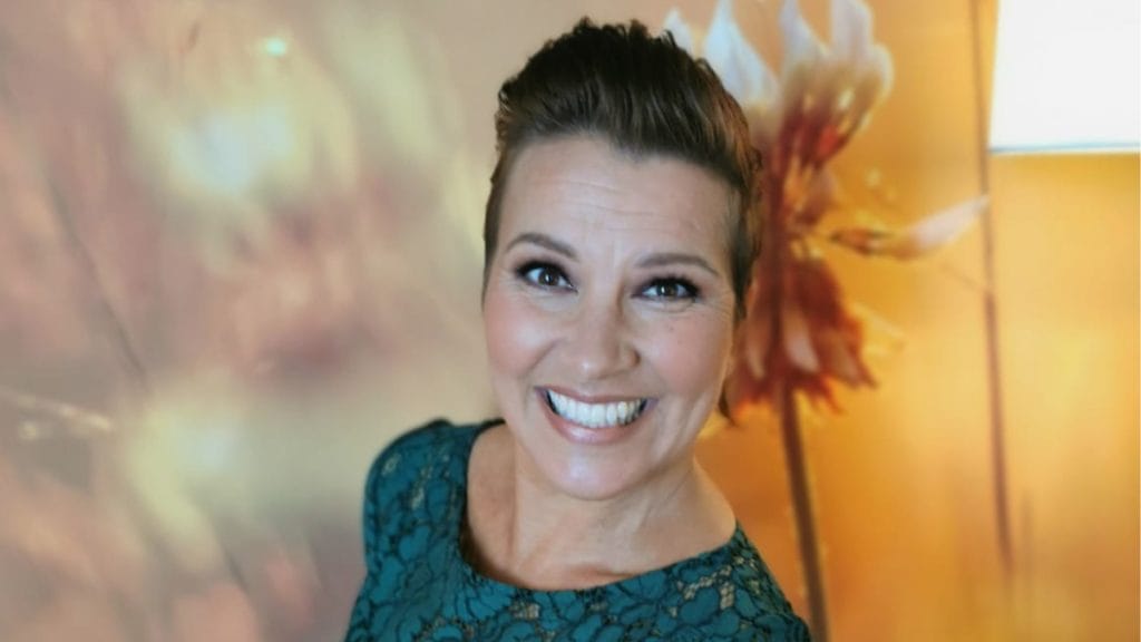 Arja Koriseva poseeraa ja hymyilee kameralle vihreässä puvussa jouluna 2025